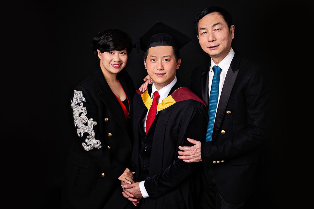 graduate portrait with a family in a studio