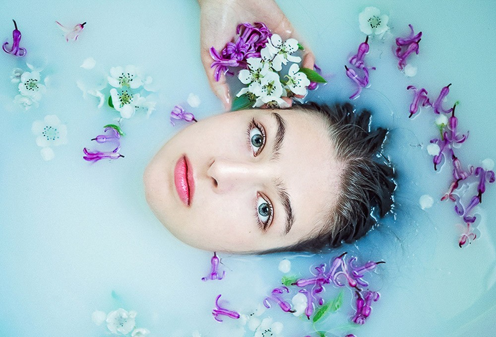 milk bath photoshoot senior portrait with flowers